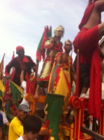The man in the red pants is sitting on a pole Cap Go Meh Festival, Singkawang, West Kalimantan